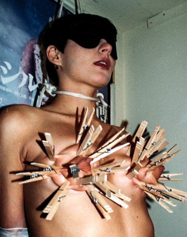 Camille, nude, blindfolded and clothespinned by Rick Savage.